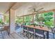 Large covered patio with dining and seating areas surrounded by lush landscaping at 2107 Desert Woods Dr, Henderson, NV 89012