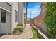View of the landscaped backyard with brick pavers and green space at 217 Turkey Creek Way, Henderson, NV 89074