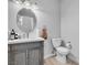 Cozy bathroom with vanity, oval mirror, and toilet, offering a clean and functional space at 217 Turkey Creek Way, Henderson, NV 89074
