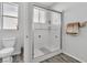 This bathroom is equipped with a toilet, glass shower, and chrome hardware against a neutral color palette at 217 Turkey Creek Way, Henderson, NV 89074