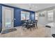 Bright dining area with a table set for eight, a door to the backyard, and ample natural light at 217 Turkey Creek Way, Henderson, NV 89074