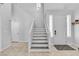 Bright foyer with staircase, tile flooring, and natural light, creating an open entry at 217 Turkey Creek Way, Henderson, NV 89074