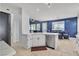 Well-lit kitchen with white cabinets, quartz countertops, stainless steel appliances, and open to the living area at 217 Turkey Creek Way, Henderson, NV 89074
