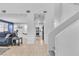 Hallway view into a well-lit kitchen and open-concept dining and living space at 217 Turkey Creek Way, Henderson, NV 89074