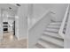 The home has a carpeted staircase with white risers next to the kitchen with stainless steel appliances at 217 Turkey Creek Way, Henderson, NV 89074