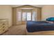 Well-lit bedroom features a bay window, neutral paint, and carpet at 2173 Point Mallard Dr, Henderson, NV 89012