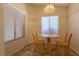 Cozy dining area with natural light, a wooden table and two chairs at 2173 Point Mallard Dr, Henderson, NV 89012