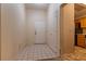 Entryway with white tile floor, white door, and partial view of the kitchen at 2173 Point Mallard Dr, Henderson, NV 89012