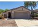 Single-story home featuring a two-car garage, desert landscaping, and covered entryway at 2173 Point Mallard Dr, Henderson, NV 89012
