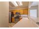 Well-lit kitchen with stainless steel appliances, wooden cabinets, and light countertops at 2173 Point Mallard Dr, Henderson, NV 89012