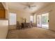 Bright living room featuring a ceiling fan and sliding glass doors to the backyard at 2173 Point Mallard Dr, Henderson, NV 89012