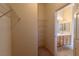 Spacious walk-in closet with wire shelves and access to a bathroom with double sinks at 2173 Point Mallard Dr, Henderson, NV 89012