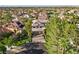 Aerial view of a beautiful home with well-maintained landscaping, mature trees and a three car garage at 2309 Prometheus Ct, Henderson, NV 89074