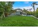 Expansive backyard with lush lawn, mature trees, and a sparkling pool, perfect for outdoor living at 2309 Prometheus Ct, Henderson, NV 89074