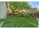 Lush backyard featuring a well-manicured lawn and mature trees, providing a serene outdoor space at 2309 Prometheus Ct, Henderson, NV 89074