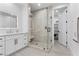 Beautiful bathroom featuring a glass shower, marble countertops, and sleek white cabinets at 2309 Prometheus Ct, Henderson, NV 89074