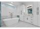 Bright bathroom with modern tub, marble accents, and white vanity at 2309 Prometheus Ct, Henderson, NV 89074