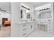 Bright bathroom featuring vanities, marble counters and modern fixtures at 2309 Prometheus Ct, Henderson, NV 89074