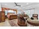 Warm bedroom with sitting area, ceiling fan, and decorative details at 2309 Prometheus Ct, Henderson, NV 89074