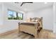 Bedroom with a window, hardwood floors, and a decorative bed with plush bedding at 2309 Prometheus Ct, Henderson, NV 89074