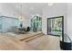 Elegant dining area featuring vaulted ceilings, a modern chandelier, and a view of the front yard at 2309 Prometheus Ct, Henderson, NV 89074