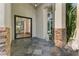 Elegant front entrance with stone accents and a modern glass door leading into the home's foyer at 2309 Prometheus Ct, Henderson, NV 89074