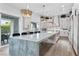 State-of-the-art kitchen with an expansive island, quartz countertops, and a view of the landscaped backyard at 2309 Prometheus Ct, Henderson, NV 89074