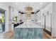 Modern kitchen boasting an oversized island with quartz countertops, pendant lighting, and stainless steel appliances at 2309 Prometheus Ct, Henderson, NV 89074