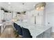 Expansive kitchen with a large island, quartz countertops, custom cabinets, and modern pendant lighting at 2309 Prometheus Ct, Henderson, NV 89074