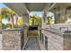 Gourmet outdoor kitchen with stone accents, built-in grill, and ample counter space for entertaining at 2309 Prometheus Ct, Henderson, NV 89074