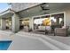 Inviting outdoor patio with comfortable seating and sliding glass doors overlooking the lush backyard at 2309 Prometheus Ct, Henderson, NV 89074