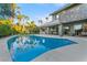 Stunning backyard featuring a sparkling pool, lush landscaping, and a beautiful home exterior at 2309 Prometheus Ct, Henderson, NV 89074