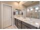 Modern bathroom featuring dual sinks, dark wood cabinets, and a glass-enclosed shower at 2711 Evolutionary Ln, Las Vegas, NV 89138
