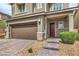 Lovely home featuring a two-car garage, brick-paved driveway, and a covered front porch at 2711 Evolutionary Ln, Las Vegas, NV 89138