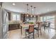 Bright kitchen with stainless steel appliances, dark cabinetry, an island, breakfast bar, and dining area access at 2711 Evolutionary Ln, Las Vegas, NV 89138