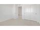 Bright bedroom with white walls, closet with sliding doors, and neutral carpet flooring at 2773 Green Envy Ave # 245, North Las Vegas, NV 89086