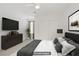 Well-lit bedroom with modern furnishings, a ceiling fan, and a large flat screen TV at 2773 Green Envy Ave # 245, North Las Vegas, NV 89086