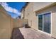 Private outdoor patio area featuring stylish pavers, a fence, and exterior of the home at 2773 Green Envy Ave # 245, North Las Vegas, NV 89086