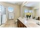 Bathroom featuring double vanity sinks, tiled floors, a window and shower at 2829 Via Florentine St, Henderson, NV 89074