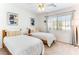 Comfortable bedroom featuring two beds, a ceiling fan and ample natural light at 2829 Via Florentine St, Henderson, NV 89074