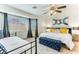 Bright bedroom features a large window, ceiling fan, and modern decor, creating a serene atmosphere at 2829 Via Florentine St, Henderson, NV 89074