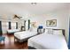 Spacious bedroom featuring three beds, hardwood floors and bright natural light at 2829 Via Florentine St, Henderson, NV 89074