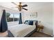 Bright bedroom features a large window and a ceiling fan. Beautiful blue accents bring the room together at 2829 Via Florentine St, Henderson, NV 89074