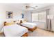 Bright, carpeted bedroom with two twin beds, natural light, and simple decor at 2829 Via Florentine St, Henderson, NV 89074