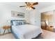 Cozy bedroom features a ceiling fan, natural light, and access to stairs to the main living area at 2829 Via Florentine St, Henderson, NV 89074