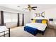 Bright bedroom features a large window, ceiling fan, and modern decor, creating a serene atmosphere at 2829 Via Florentine St, Henderson, NV 89074