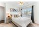 Bright bedroom featuring a queen-size bed, carpeted floors, and large window at 2829 Via Florentine St, Henderson, NV 89074