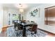 Dining room featuring a large wooden table set on an oversized rug beneath a decorative pendant light at 2829 Via Florentine St, Henderson, NV 89074