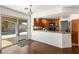 Bright kitchen boasts wood cabinets, granite counters, and sliding doors opening to a refreshing pool at 2829 Via Florentine St, Henderson, NV 89074