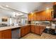 This bright kitchen features wood cabinetry, granite countertops, and modern stainless steel appliances at 2829 Via Florentine St, Henderson, NV 89074